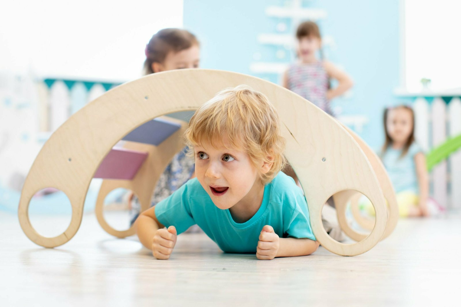 A smiling toddler riding a NEWTRONX Toddler Tricycle, excitedly exploring the outdoors while developing essential motor skills and enjoying physical activity.