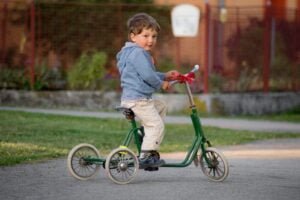 An illustration of the evolution of tricycles over time, starting from a classic vintage design to a modern and sleek version.