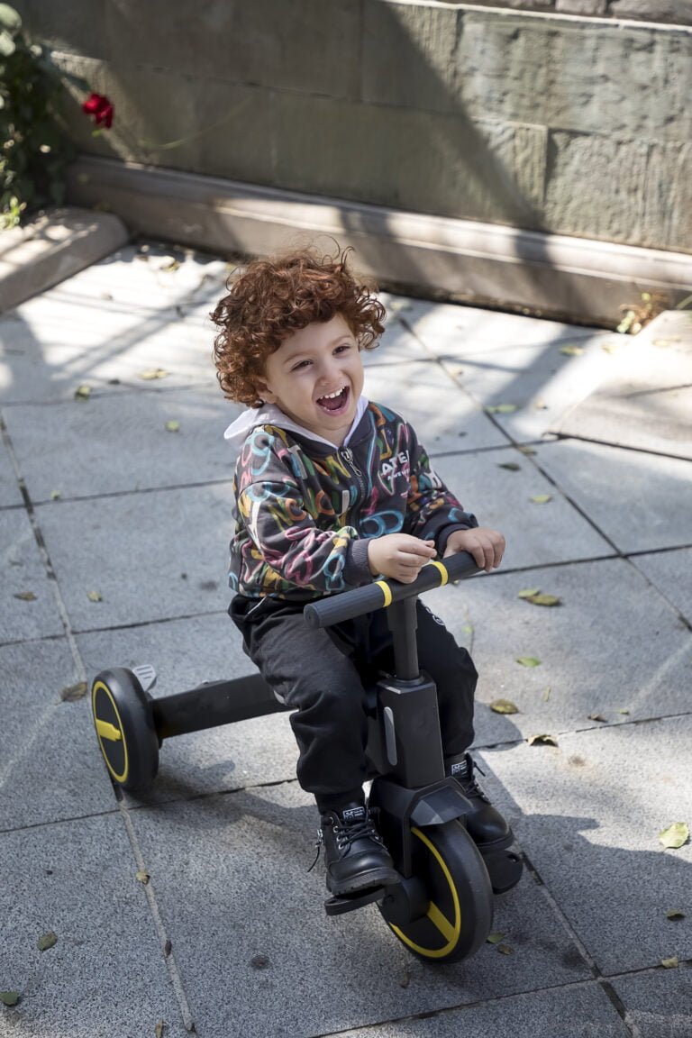 Child playing with a Newtronx foldable trike